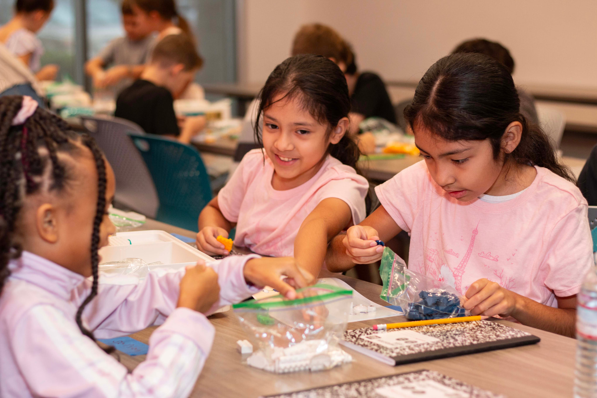 Students sorting LEGO pieces together during a science build
