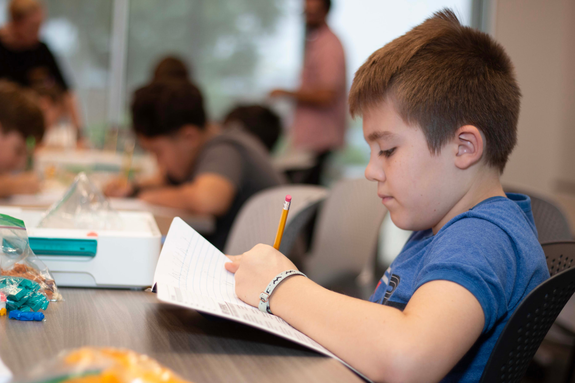 Student recording observations in a science notebook