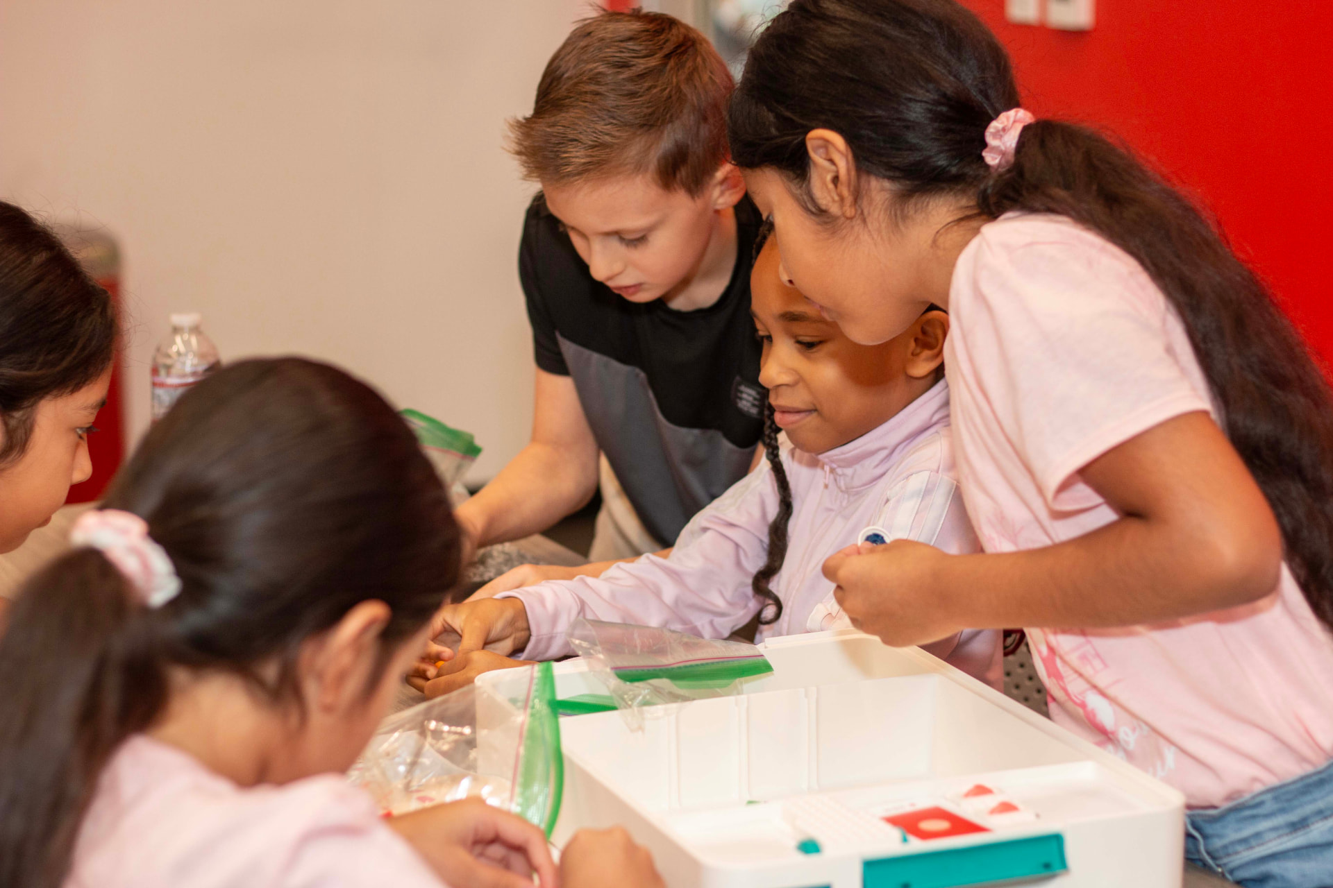 Students gathered around a LEGO Education science kit