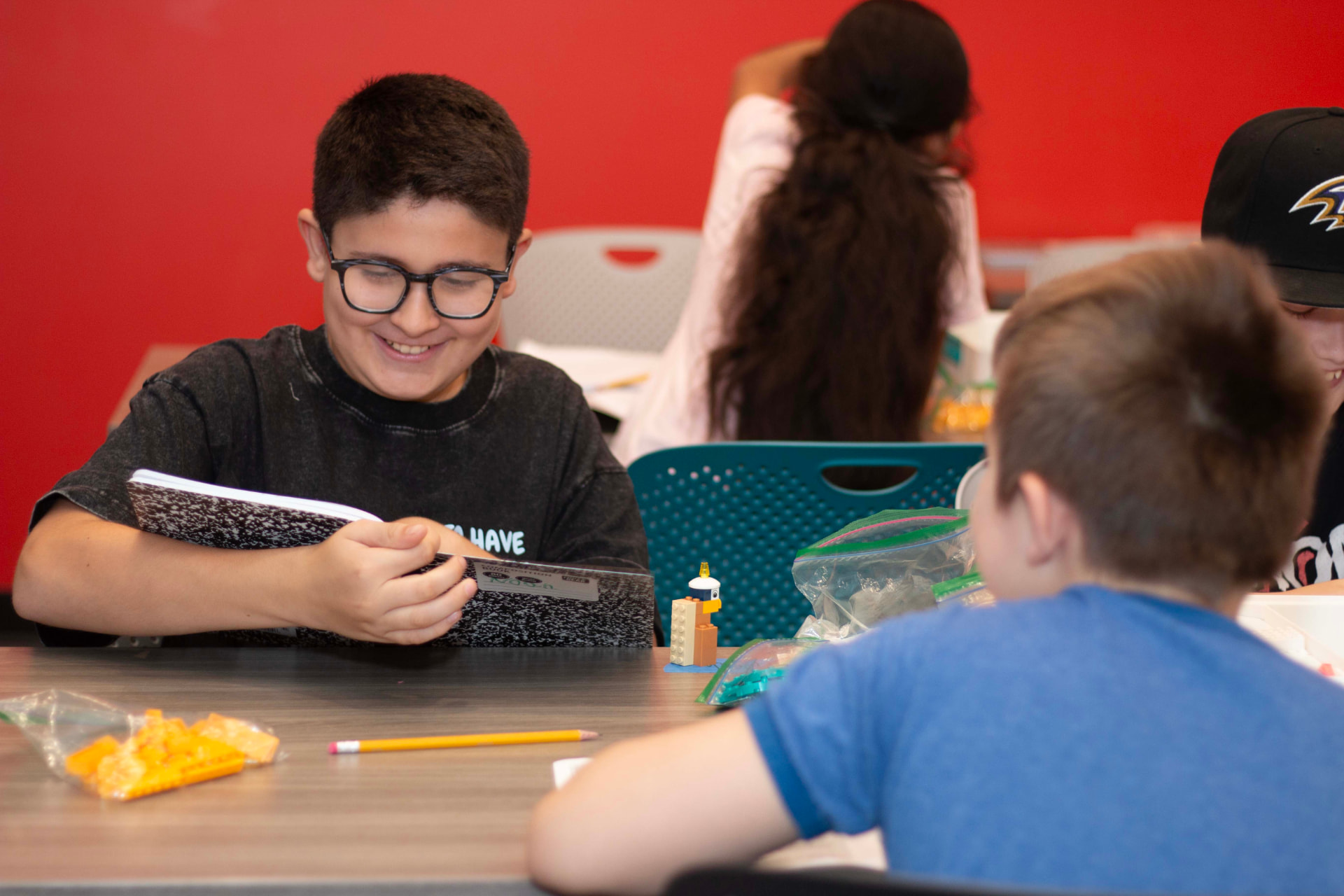 Student smiling while working on a LEGO science build