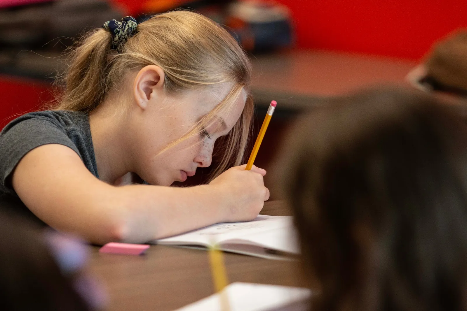Focused student drawing with a pencil