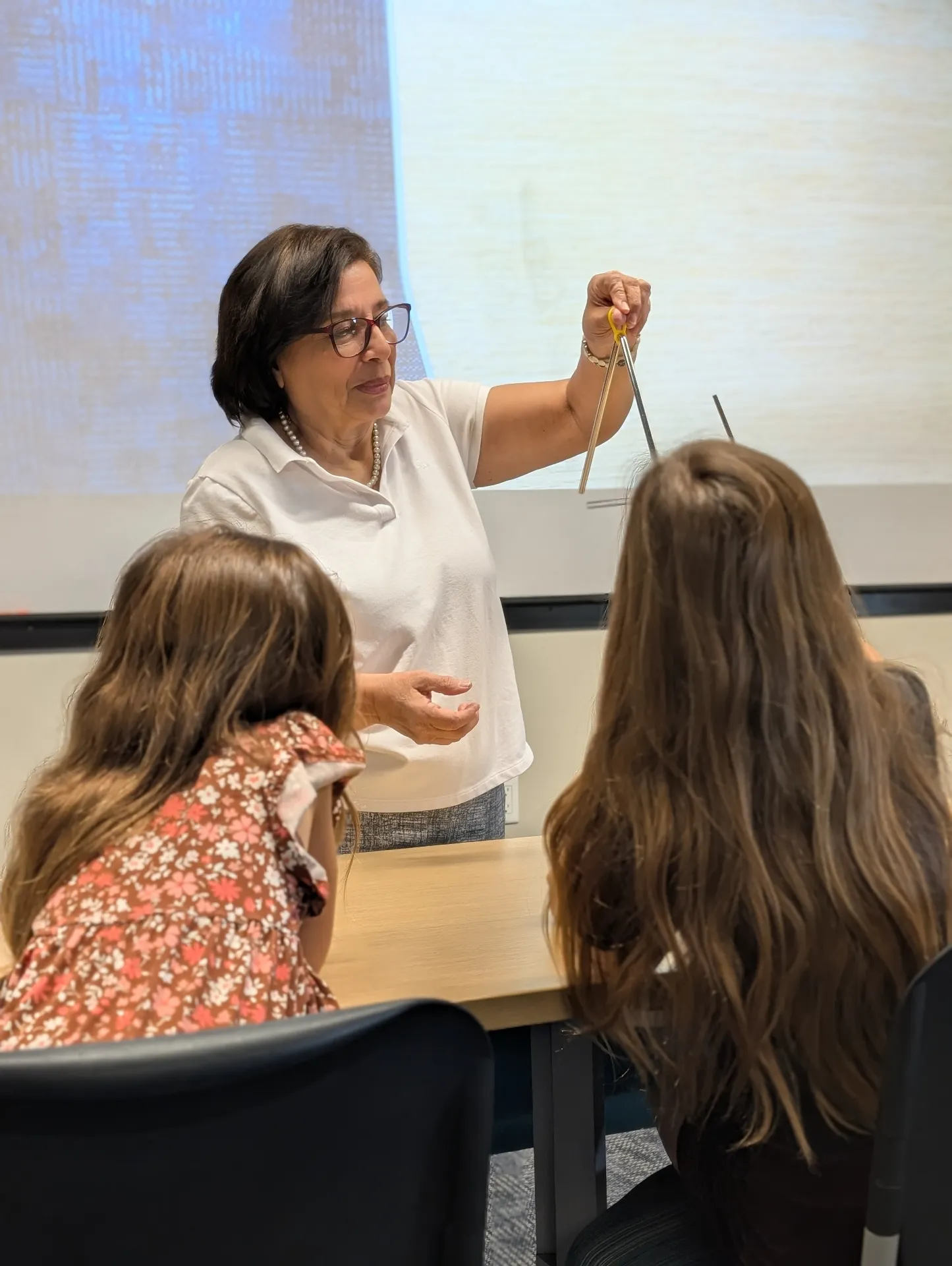 Spanish teacher demonstrating a hands-on lesson to students